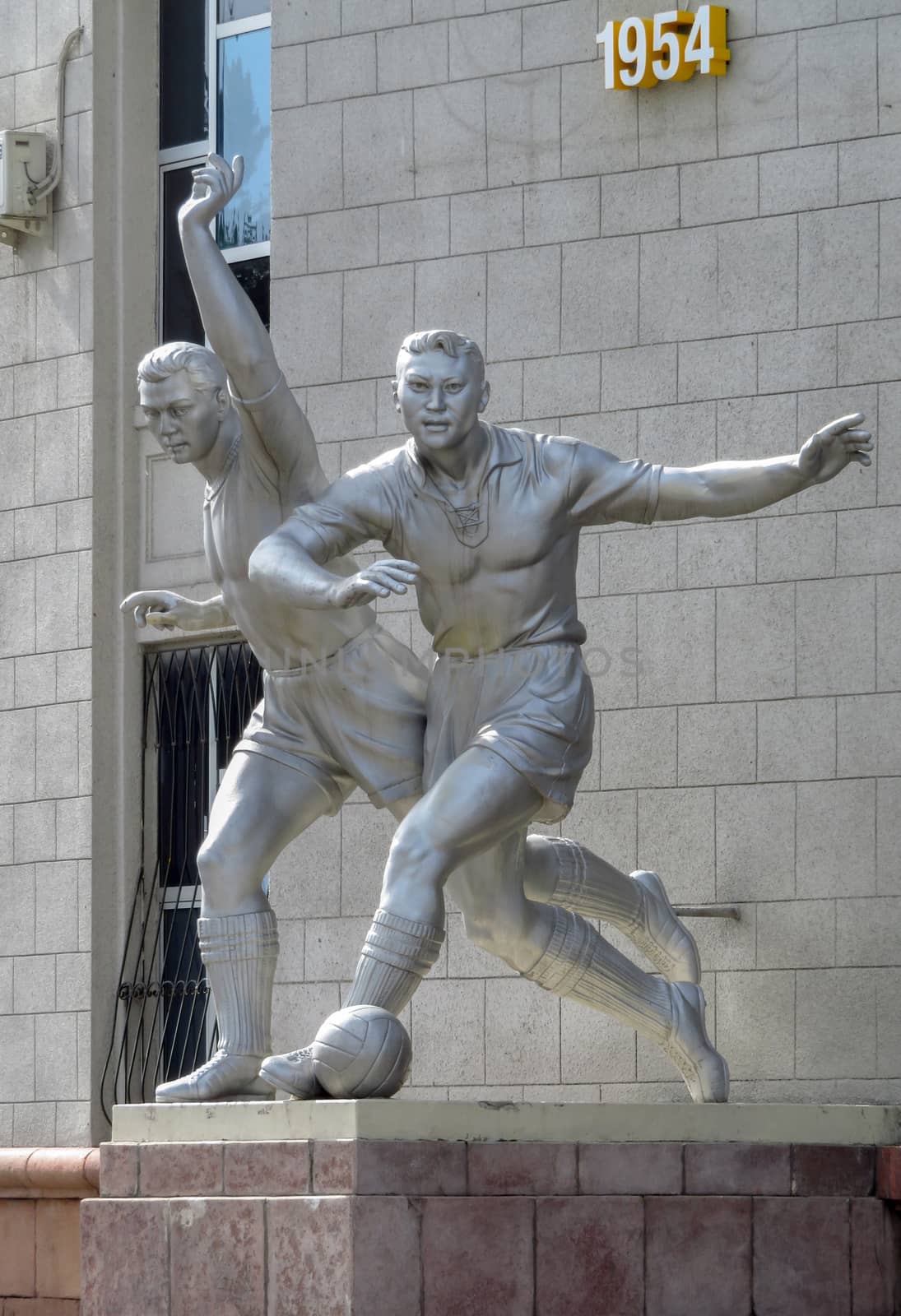 ALMATY, KAZAKHSTAN - MAY 21, 2017: Old sculpture of football players located near The Central Stadium of Almaty city, Kazakhstan.

Almaty, Kazakhstan - May 21, 2017: Old sculpture of football players located near The Central Stadium of Almaty city, Kazakhstan.
