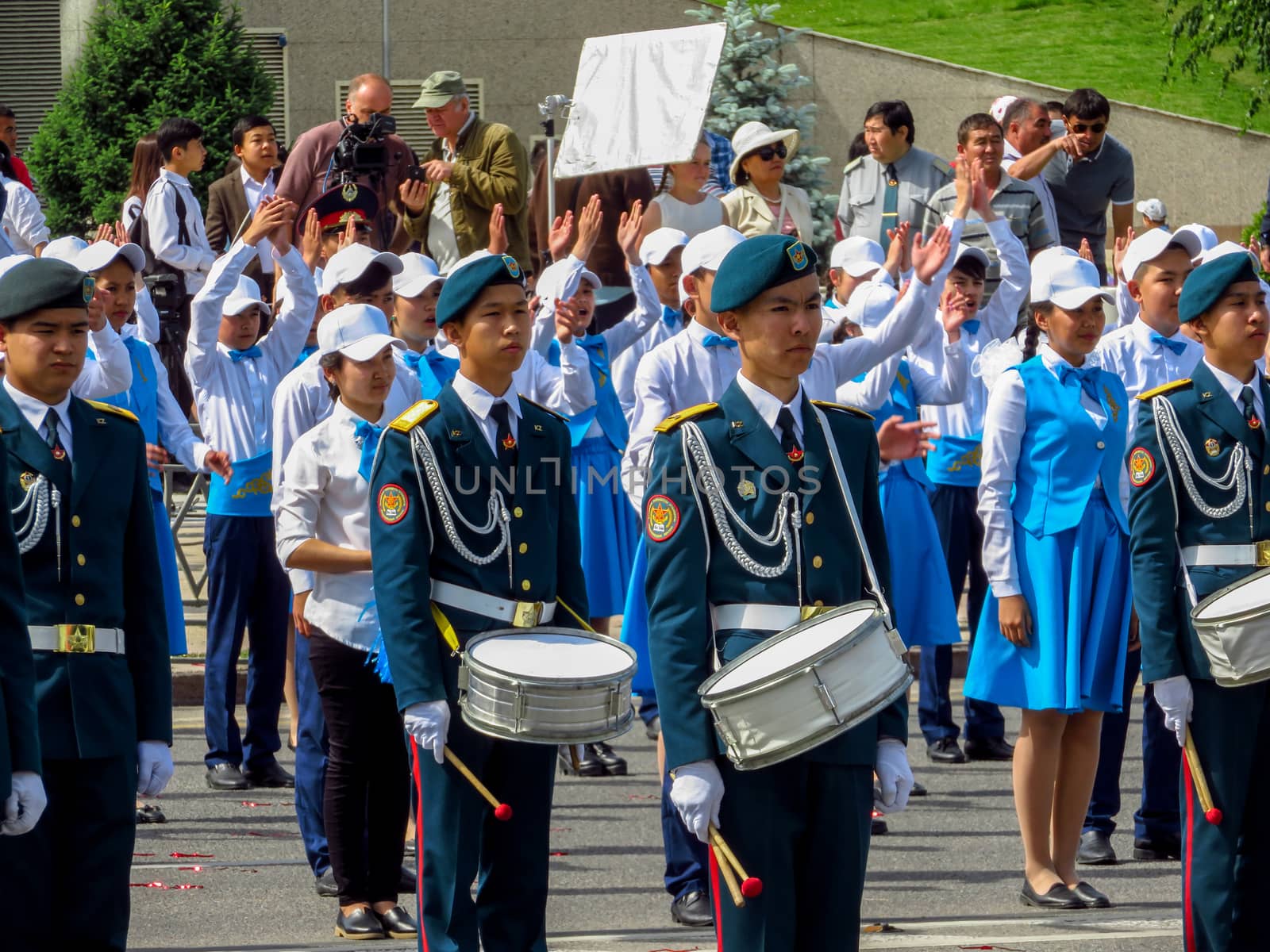 ALMATY, KAZAKHSTAN - JUNE 1, 2017: Solemn parade of children's and youth musical orchestras and ensembles on the Republic Square. More than 5,000 schoolchildren of the megapolis took part in the parade.

Almaty, Kazakhstan - June 1, 2017: Solemn parade of children's and youth musical orchestras and ensembles on the Republic Square. More than 5,000 schoolchildren of the megapolis took part in the parade.
