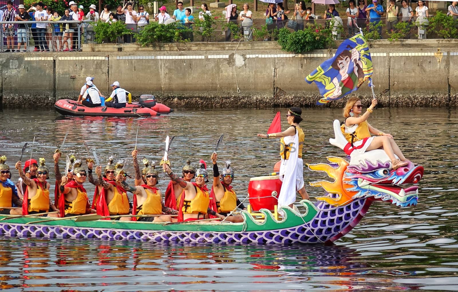 KAOHSIUNG, TAIWAN -- JUNE 20, 2015: A Dragon Boat team is dressed up as computer game characters for promotional purposes during the annual Dragon Boat Festival.
