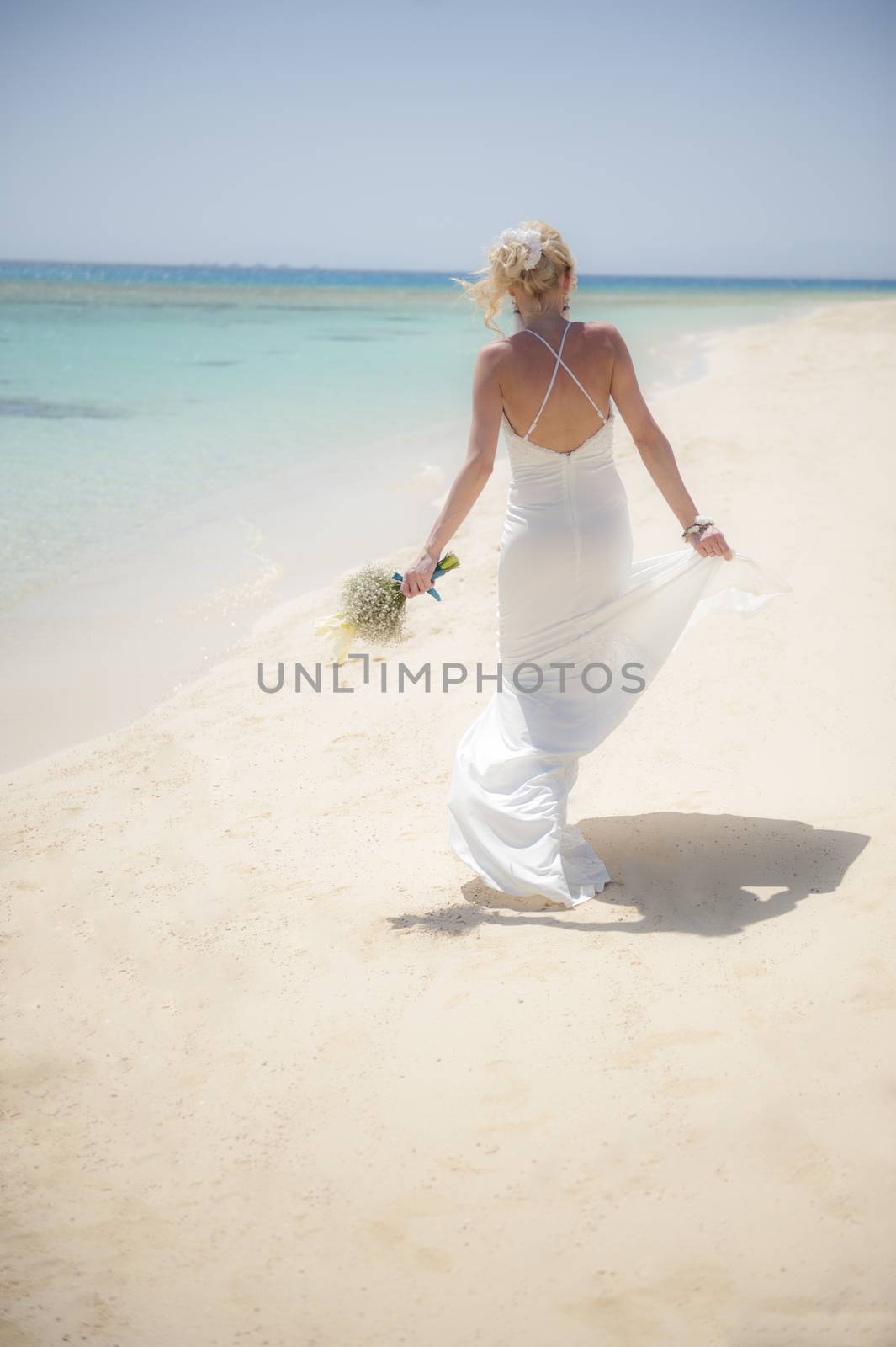 Beautiful bride on a tropical beach wedding day by paulvinten