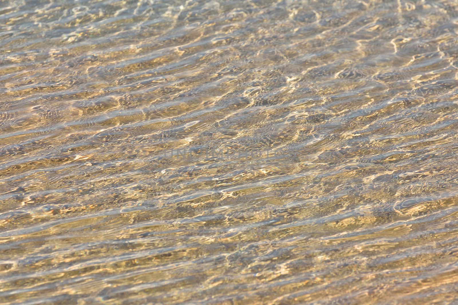 Natural clear beach sea water textured ripples in coastal pool, Mossel Bay, South Africa