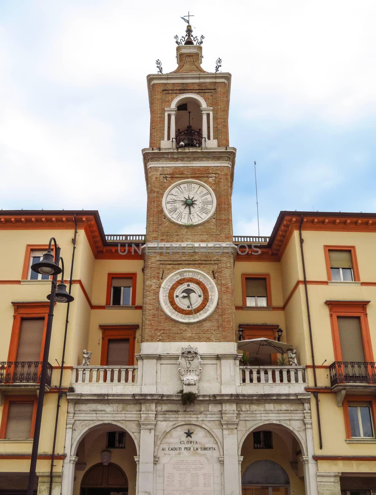 Ancient clock tower on the square Piazza tre Martiri in Rimini, Italy