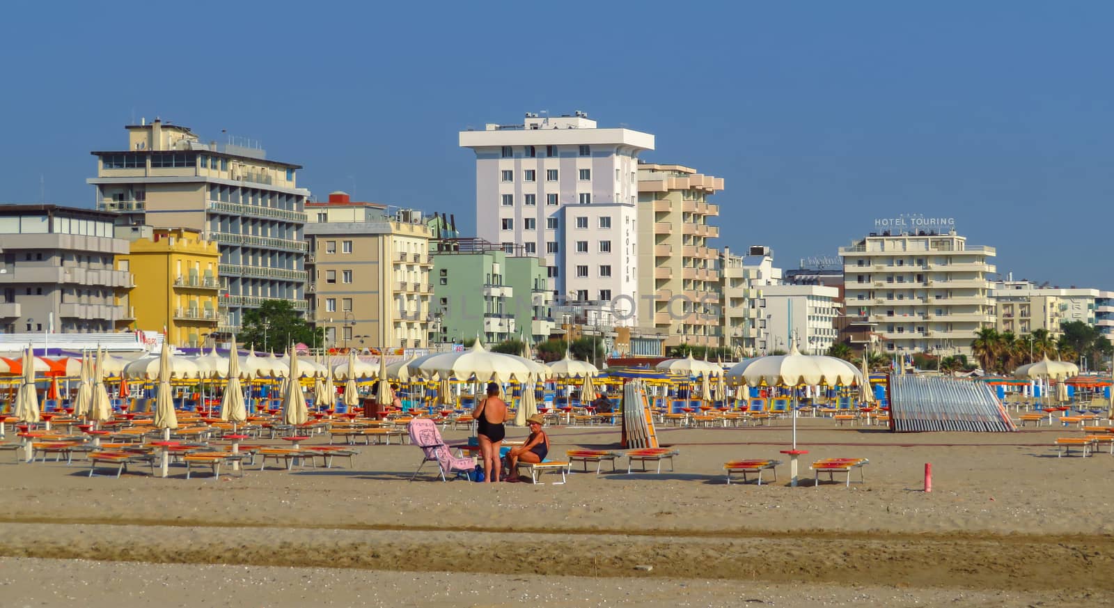 Rimini, Italy - June 13, 2017: Morning Rimini beach with sun beds and umbrellas.