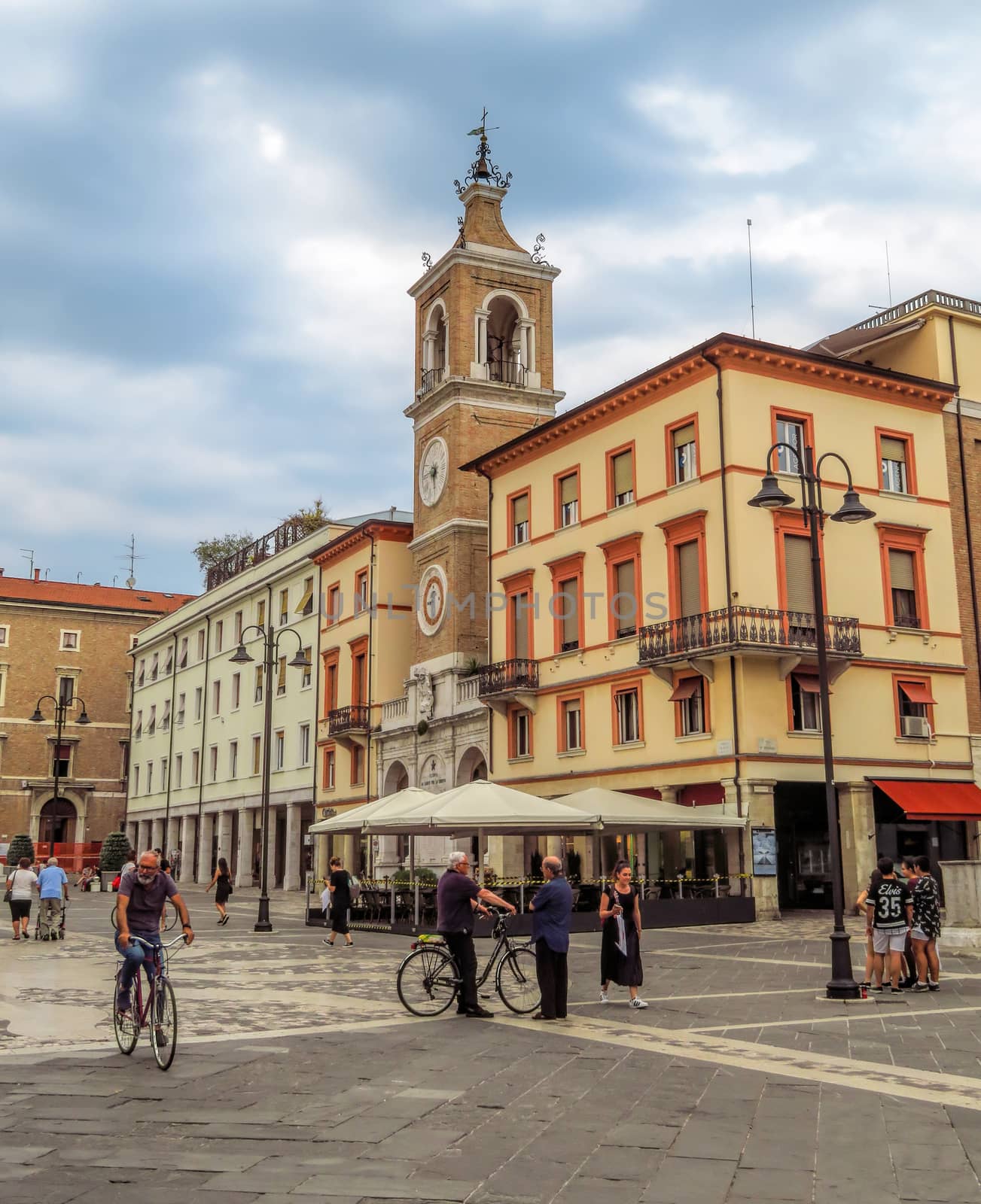 Rimini, Italy - June 14, 2017: The square Piazza tre Martiri with the ancient clock tower in Rimini, Italy