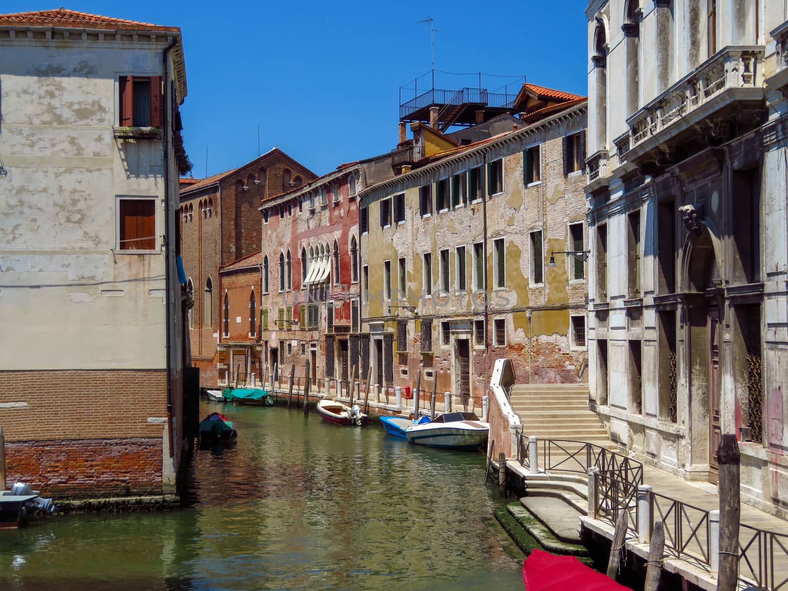 View from water canal to old buildings in Venice, Italy