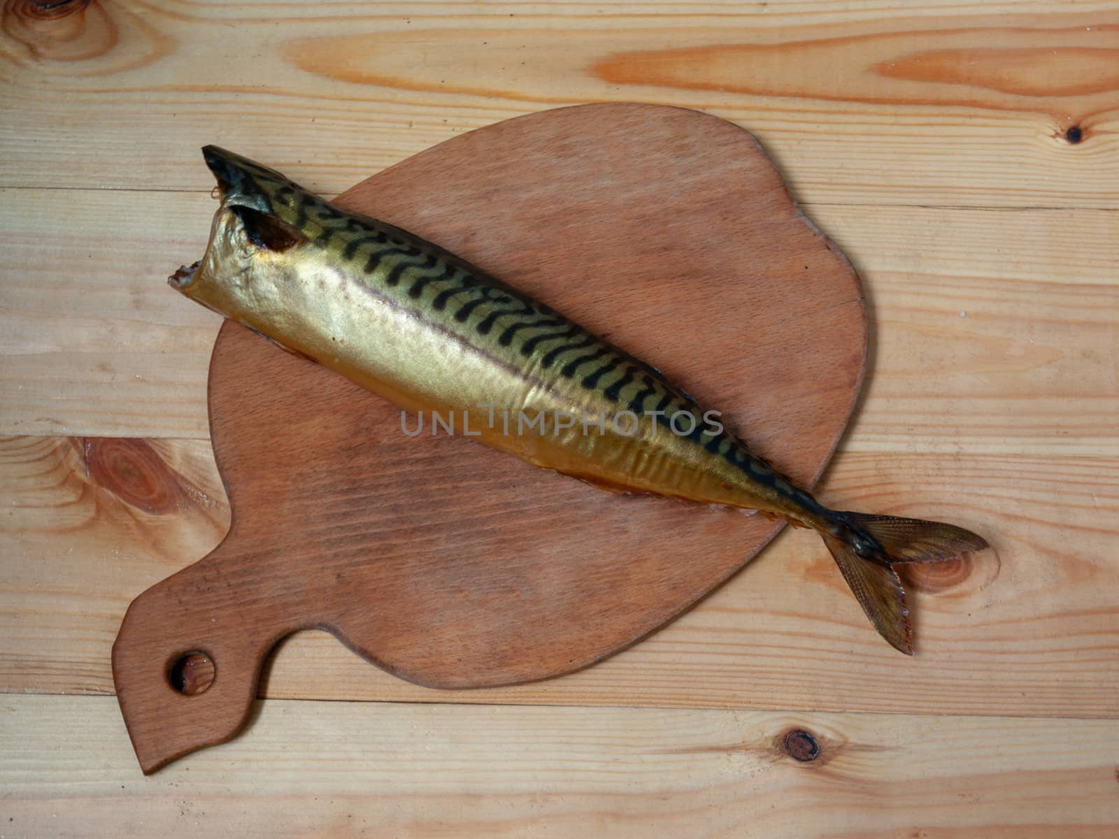 Smoked headless mackerel on a cutting board