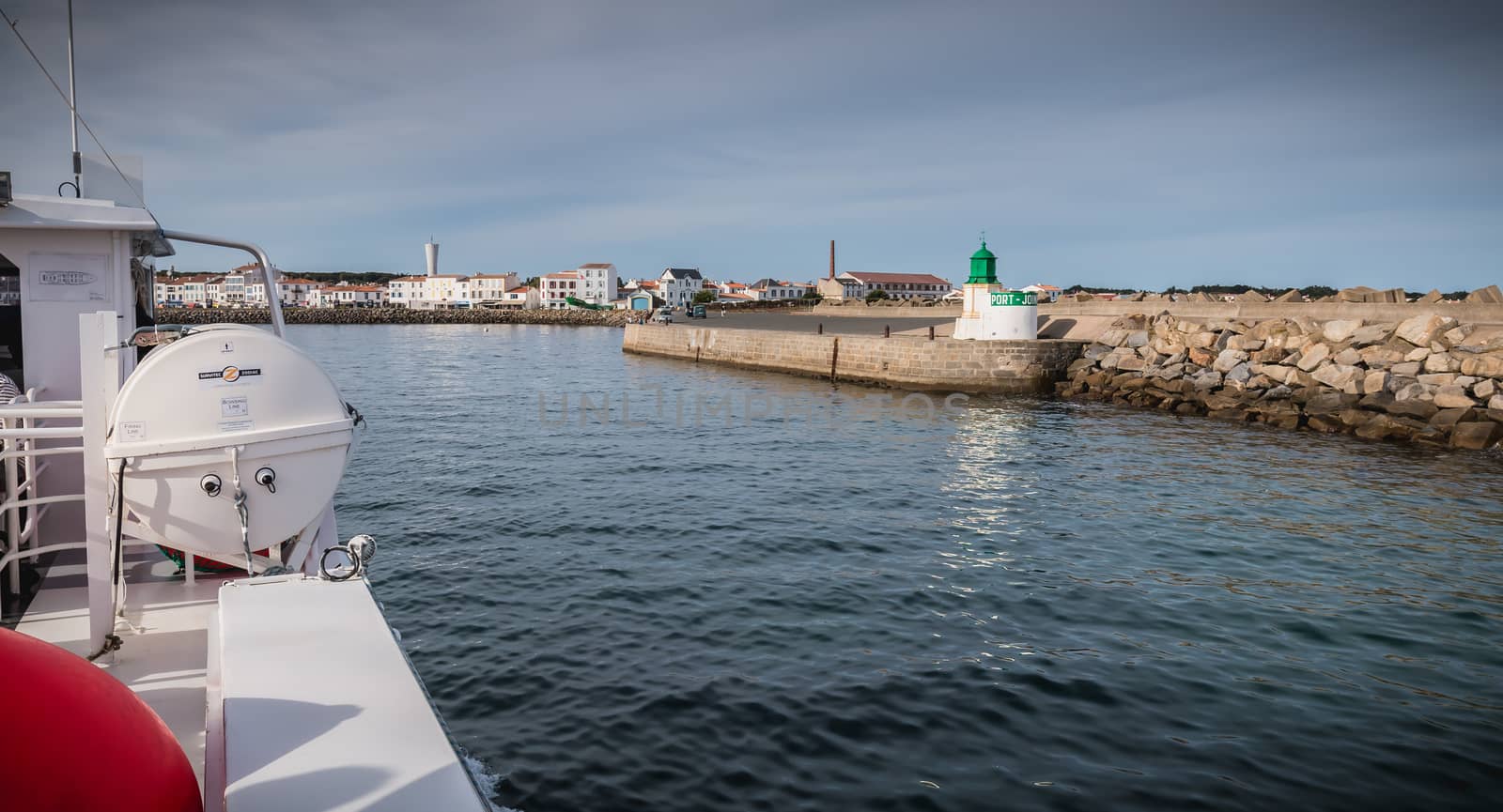 Ile d Yeu, France - September 16, 2018: View of the bridge of a ferry that enters the harbor of the island of Yeu where travelers are sitting to admire the show on a summer day