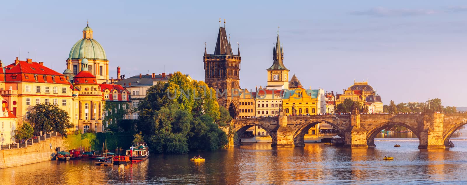 Scenic view of the Old Town pier architecture and Charles Bridge over Vltava river in Prague, Czech Republic. Prague iconic Charles Bridge (Karluv Most) and Old Town Bridge Tower at sunset, Czechia.