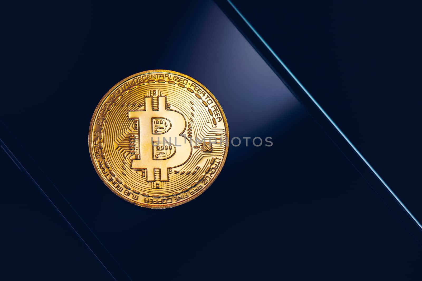 Bitcoin symbol over mobile screen, minimalist approach. Bitcoin on stock market. New digital money. Golden Bitcoin over smartphone display.