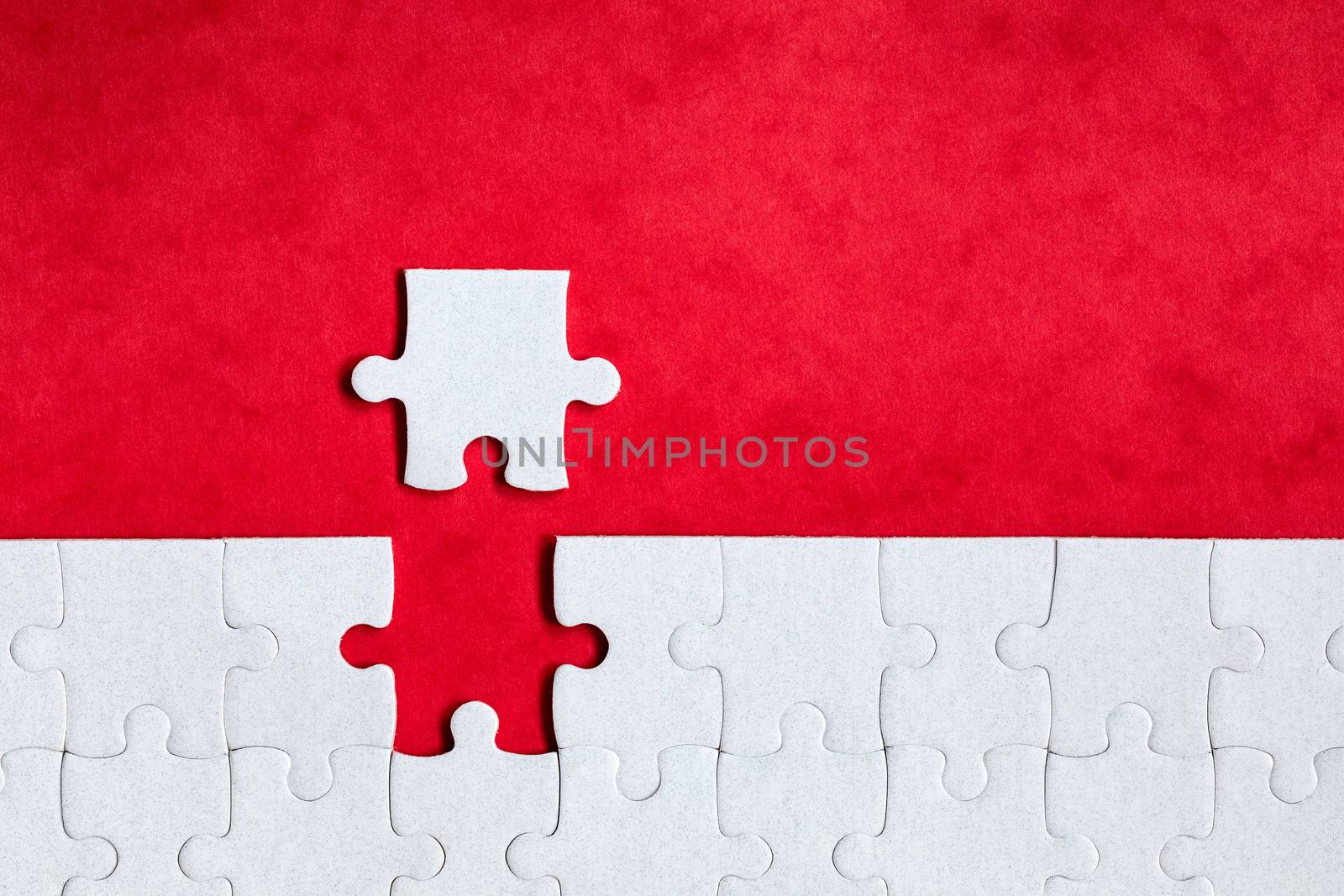 Closeup of jigsaw puzzle isolated. Missing jigsaw puzzle piece, business concept for completing the puzzle piece. Group of puzzle and a puzzle piece. Teamwork concept. Think difference concept. 
