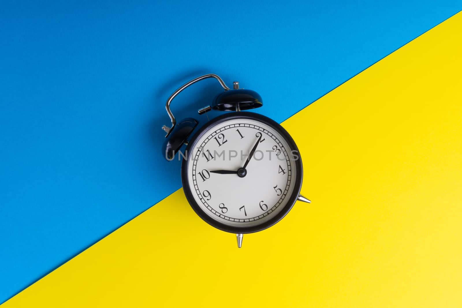 Alarm clock on a blue and yellow background by silverwings