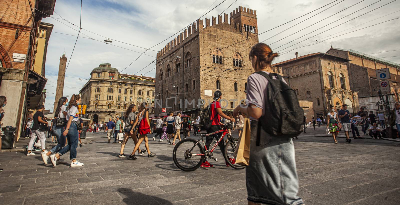 BOLOGNA, ITALY 17 JUNE 2020: Palazzo Re Enzo: a famous historic building in Bologna, Italy with people walking in the square