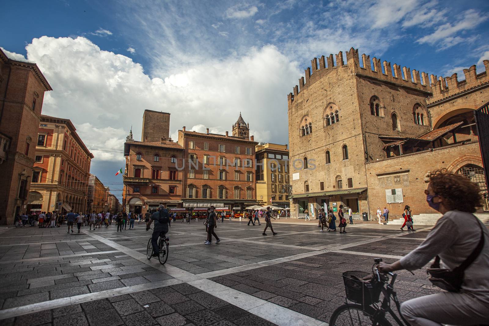 BOLOGNA, ITALY 17 JUNE 2020: Palazzo Re Enzo: a famous historic building in Bologna, Italy with people walking in the square