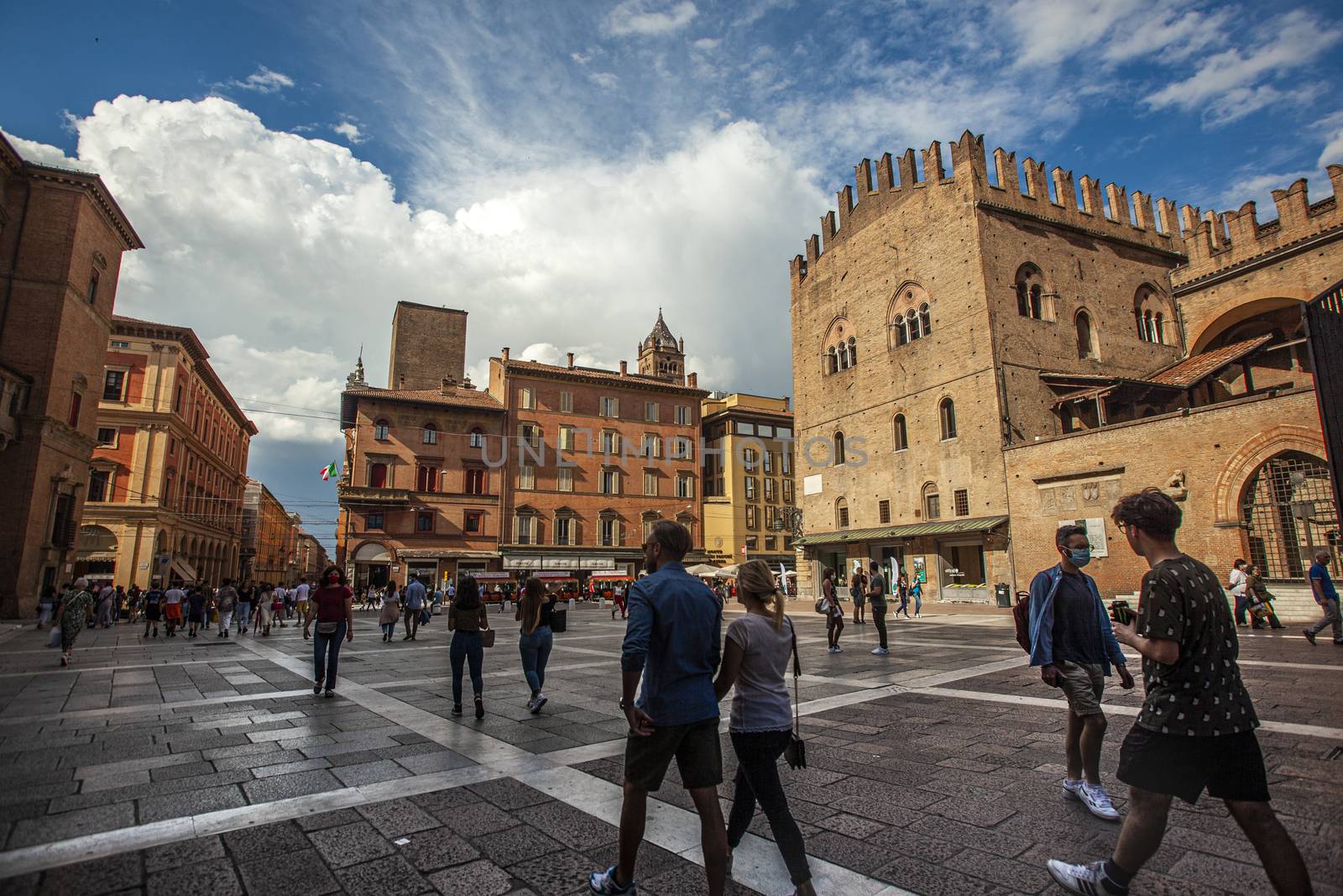 BOLOGNA, ITALY 17 JUNE 2020: Palazzo Re Enzo: a famous historic building in Bologna, Italy with people walking in the square