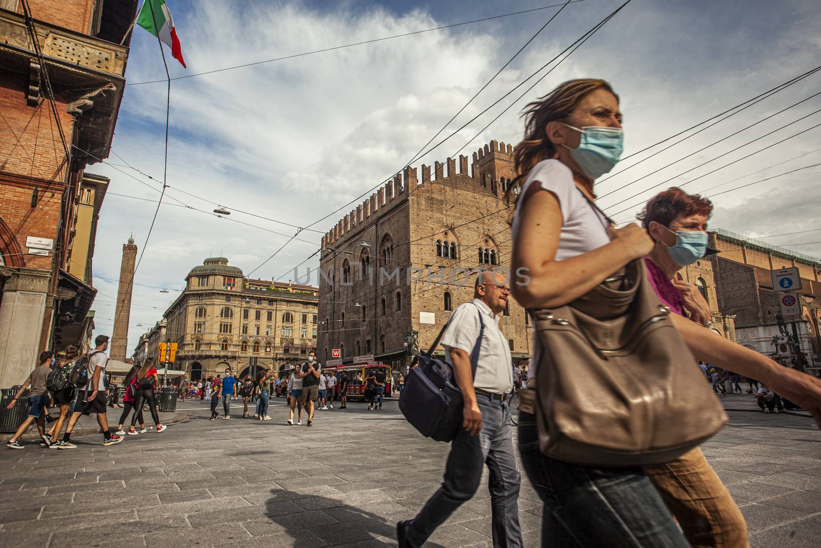 BOLOGNA, ITALY 17 JUNE 2020: Palazzo Re Enzo: a famous historic building in Bologna, Italy with people walking in the square