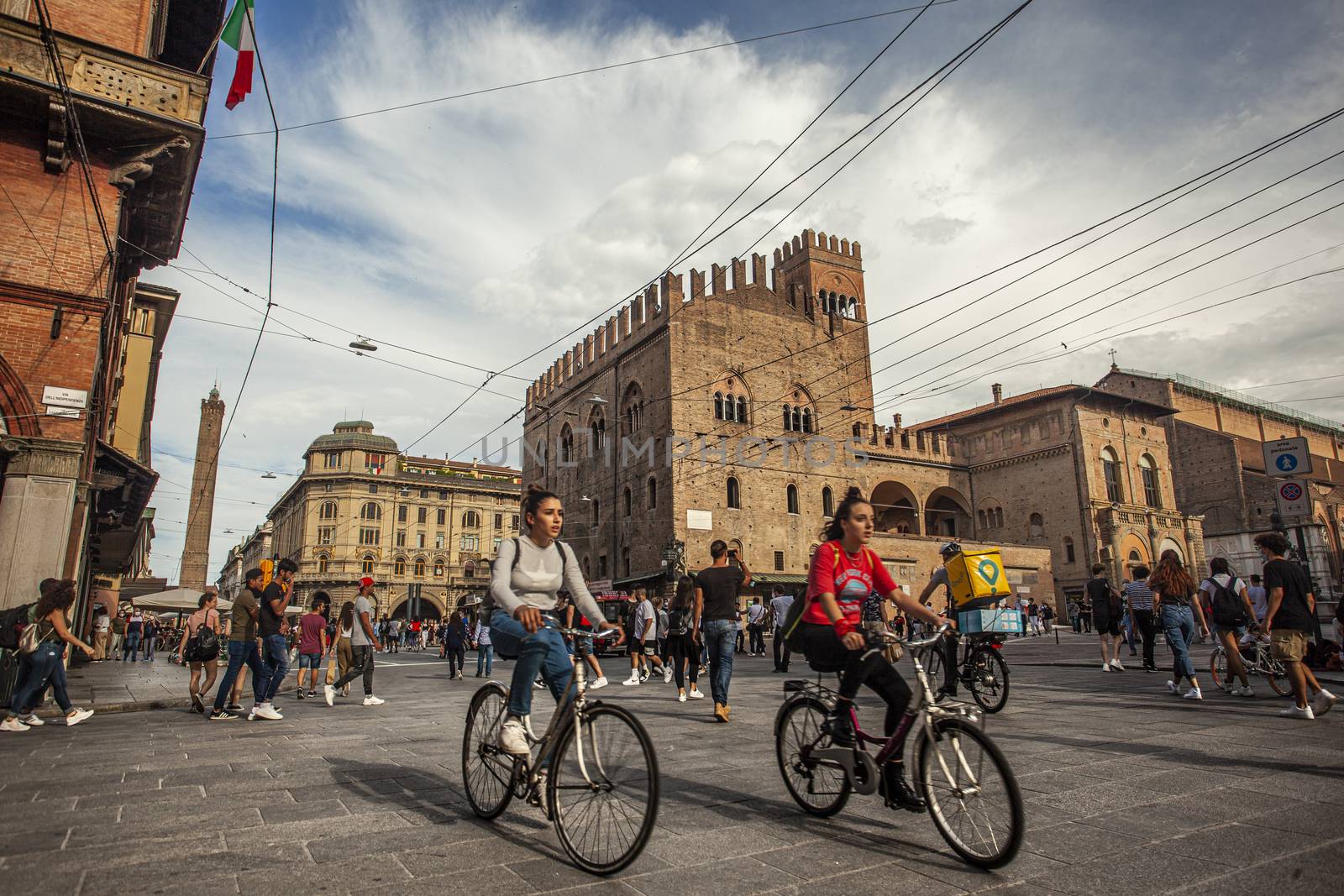 BOLOGNA, ITALY 17 JUNE 2020: Palazzo Re Enzo: a famous historic building in Bologna, Italy with people walking in the square