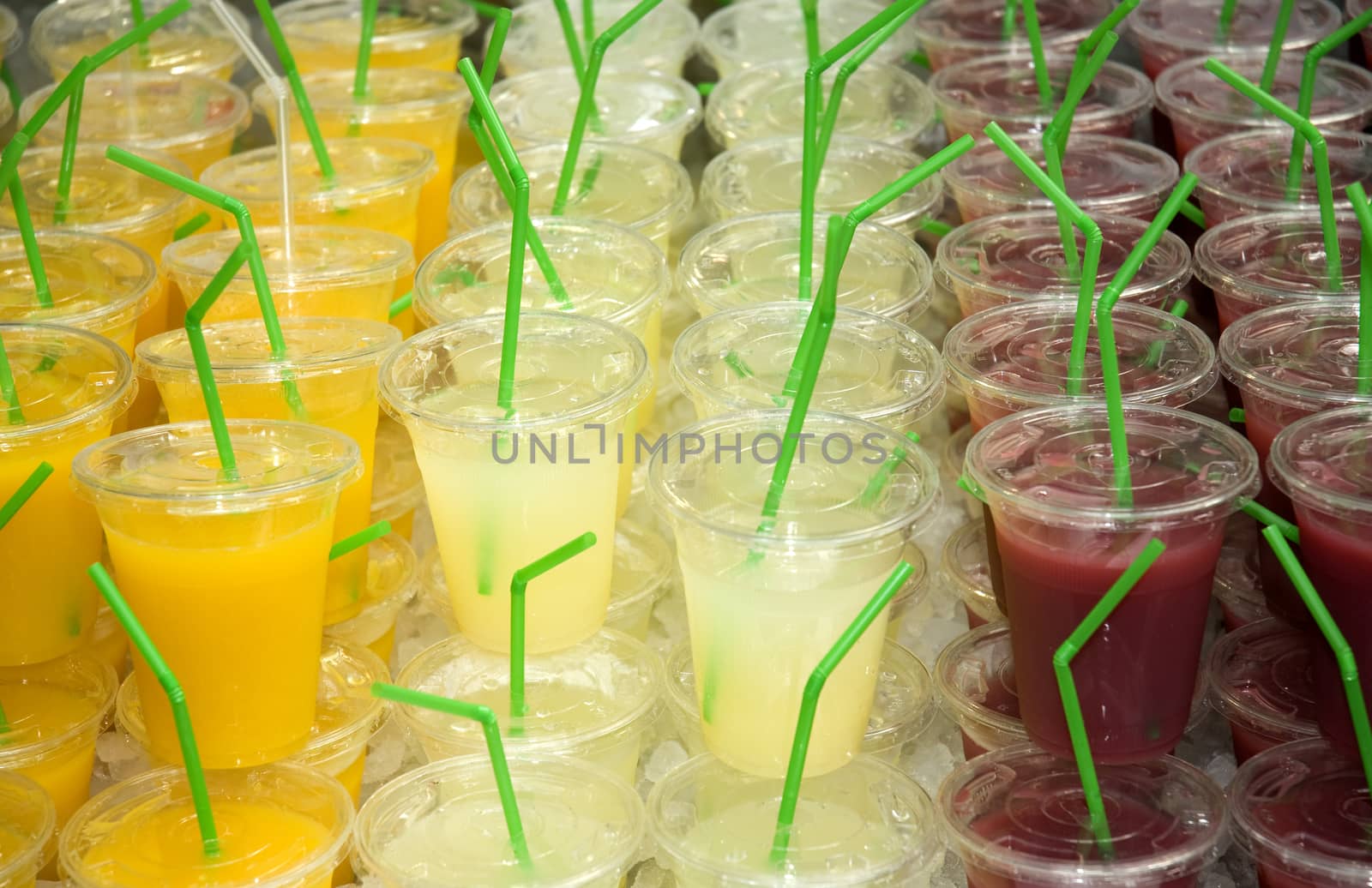 A selection of freshly made fruit juices on a market stall