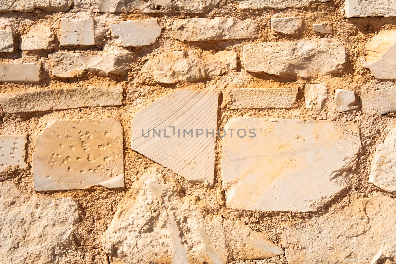 Sand stone brick wall surface, rock texture background tile structure. Aged build block material for grunge antique  architecture background. sandstone detail textured effect with cracks