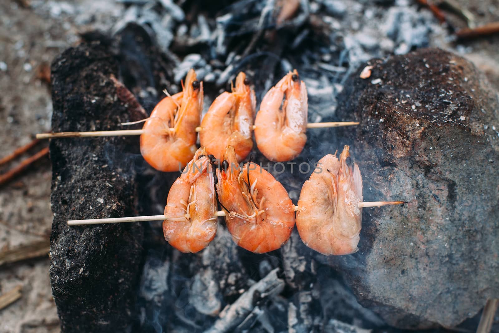 King prawns grilled on charcoal. Food outdoors. Cooking at the stake. Picnic