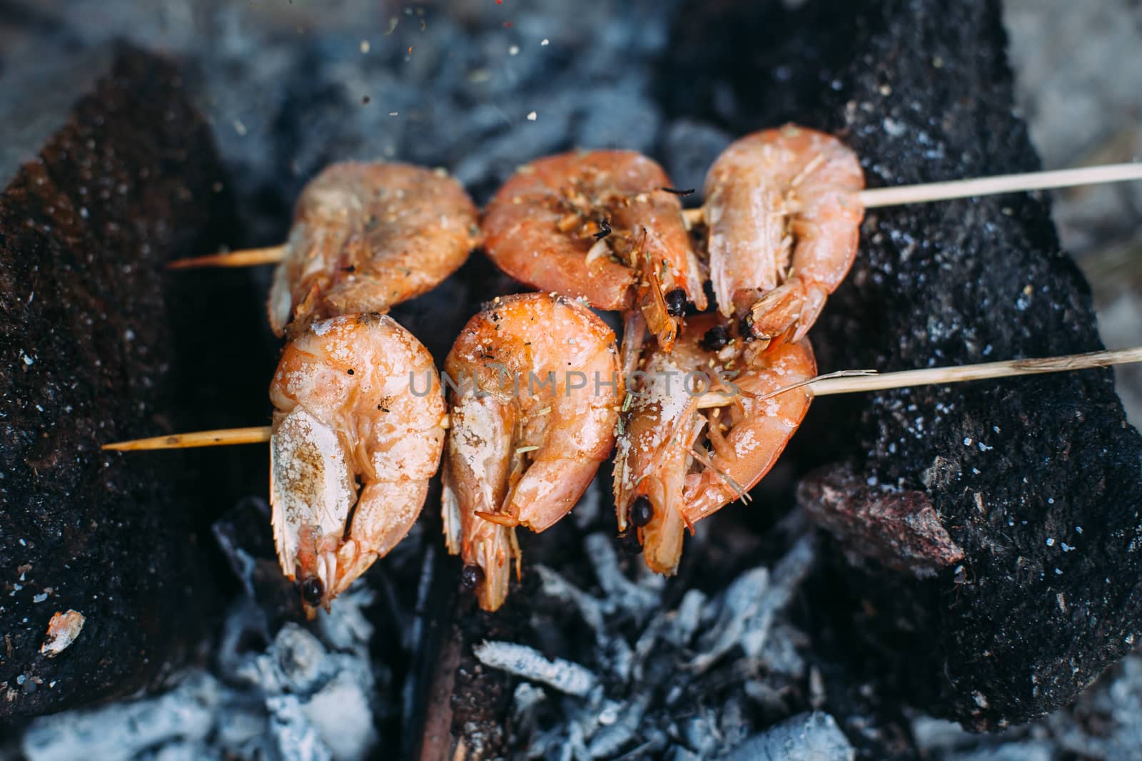 King prawns grilled on charcoal. Food outdoors. Cooking at the s by Opikanets