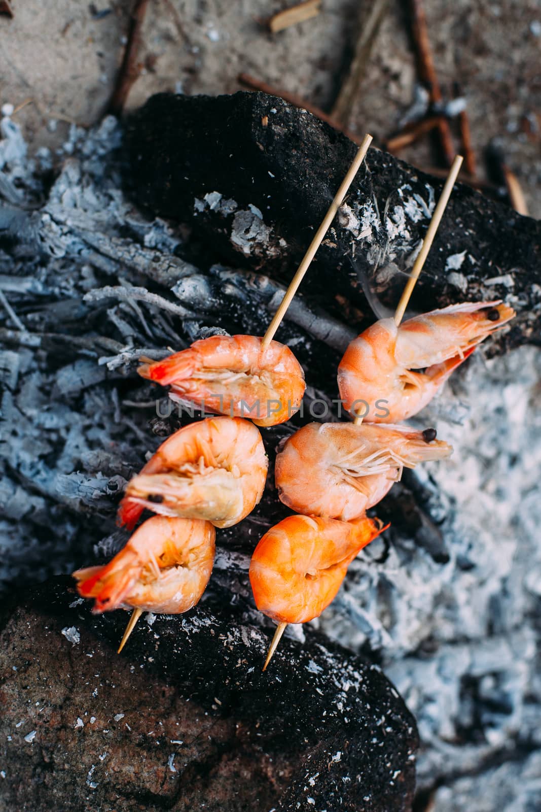 King prawns grilled on charcoal. Food outdoors. Cooking at the stake. Picnic