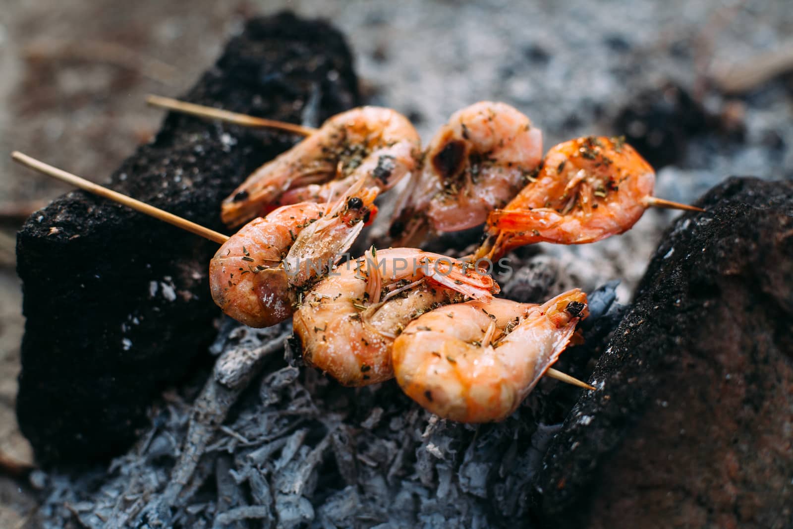 King prawns grilled on charcoal. Food outdoors. Cooking at the stake. Picnic