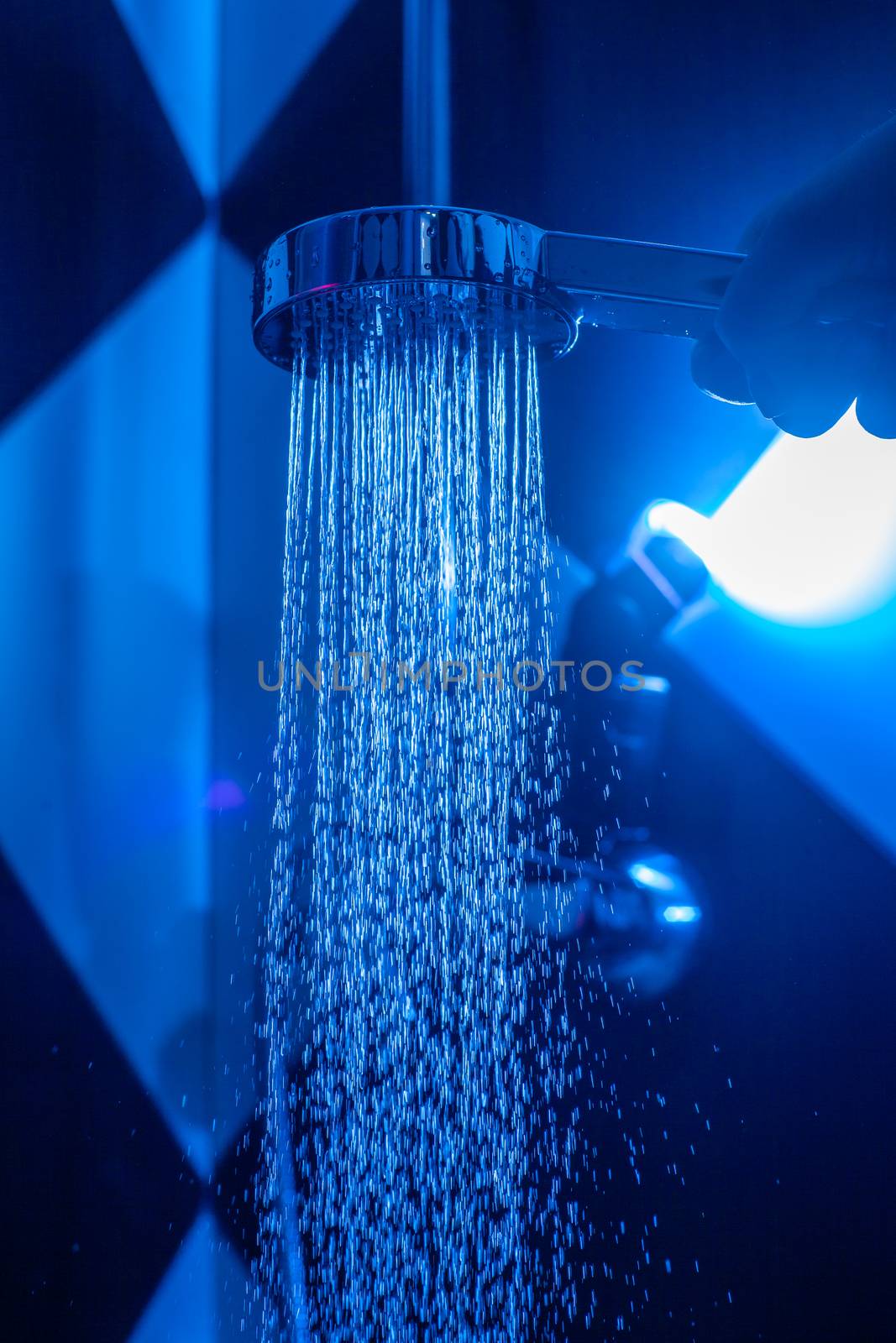 Girl holds a watering can in a shower cabin with blue backlight. by Opikanets