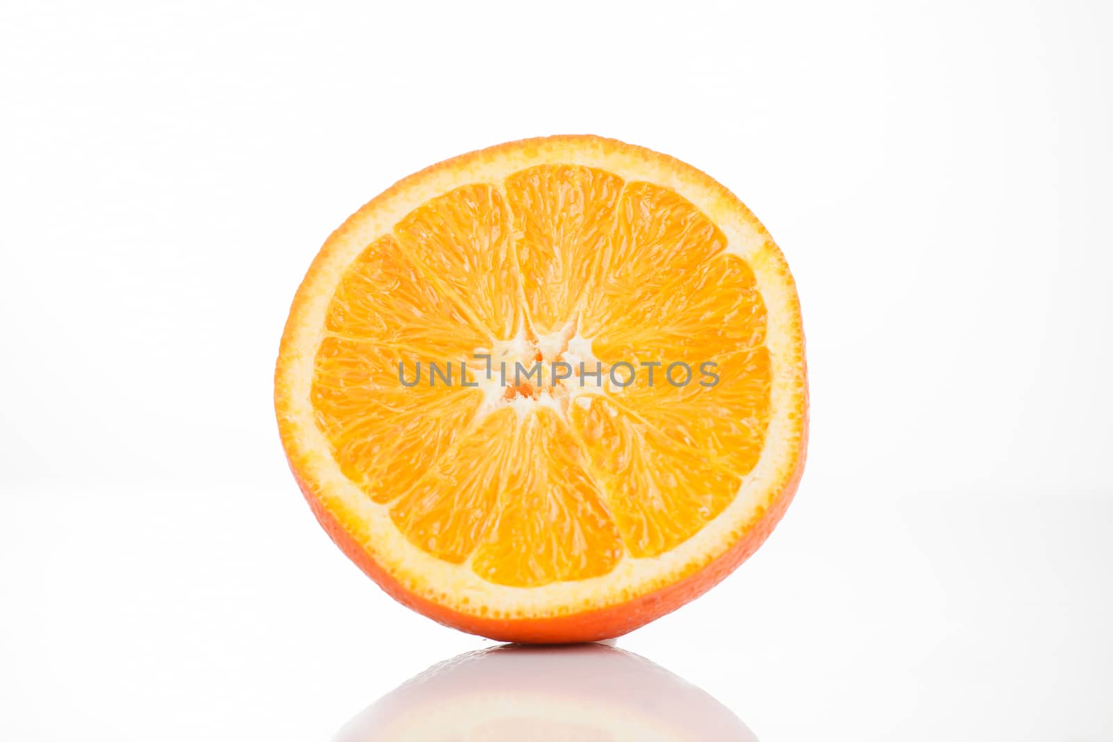 Sliced ​​orange on a white background with reflection at the bottom. Isolated photo of citrus