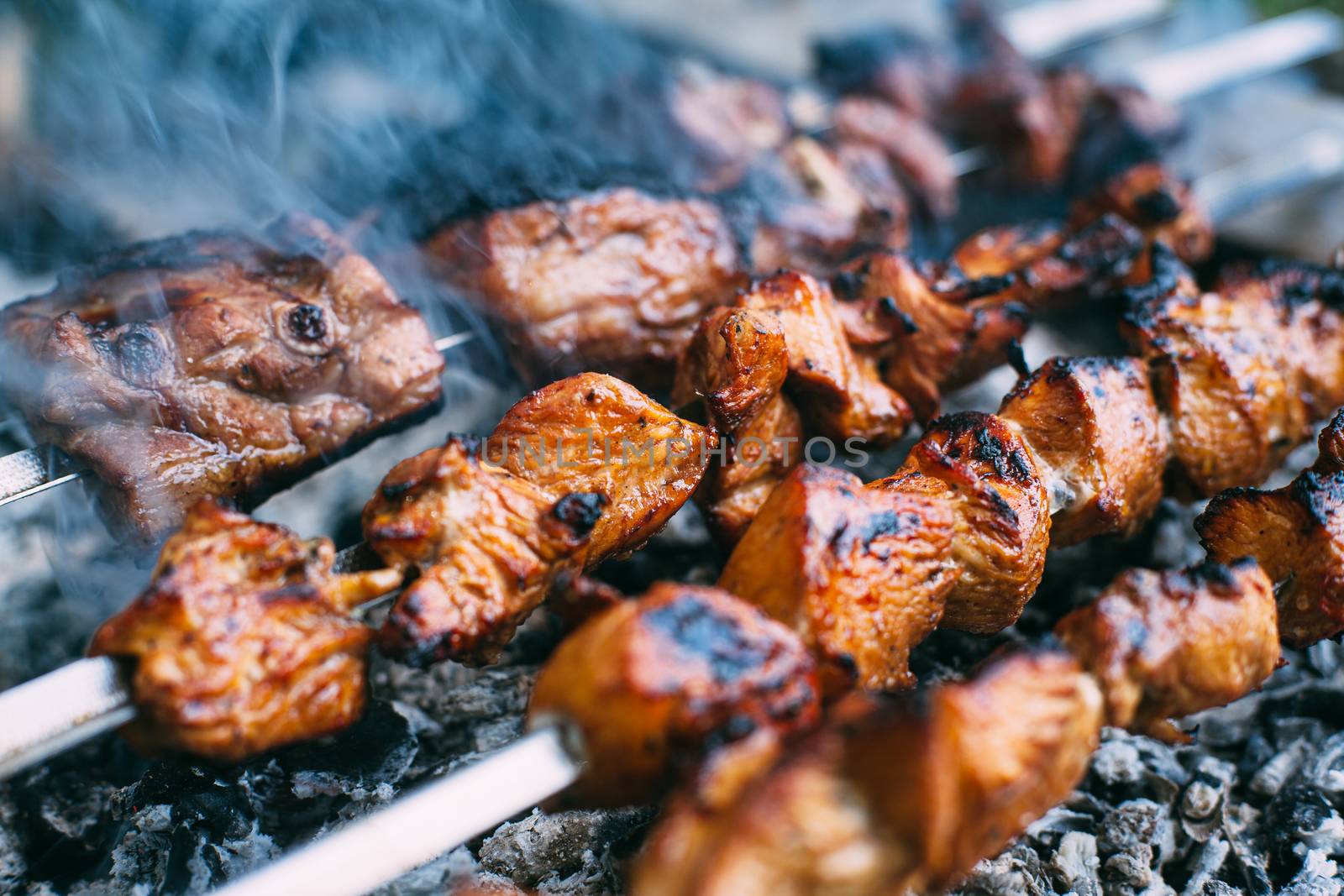 Skewers of pork ribs and chicken on skewers. Grilled meat. Cooki by Opikanets