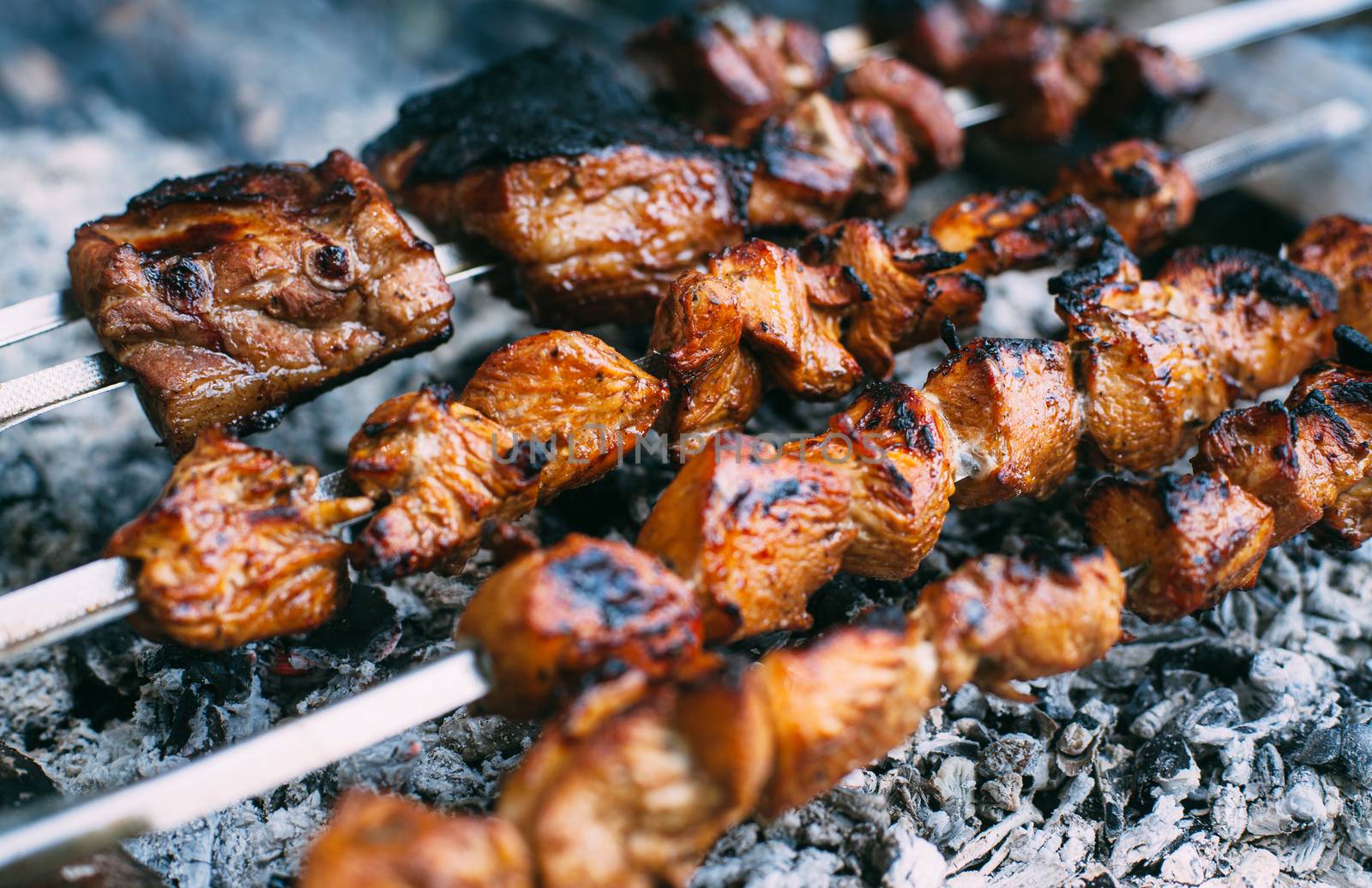 Skewers of pork ribs and chicken on skewers. Grilled meat. Cooki by Opikanets