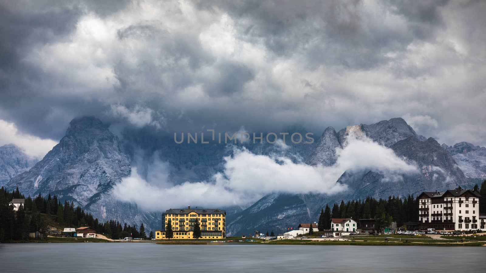 Misurina Lake in the Dolomites mountains in Italy near Auronzo di Cadore on a cloudy day, Sorapiss mountain in the background. South Tyrol, Dolomites, Italy.