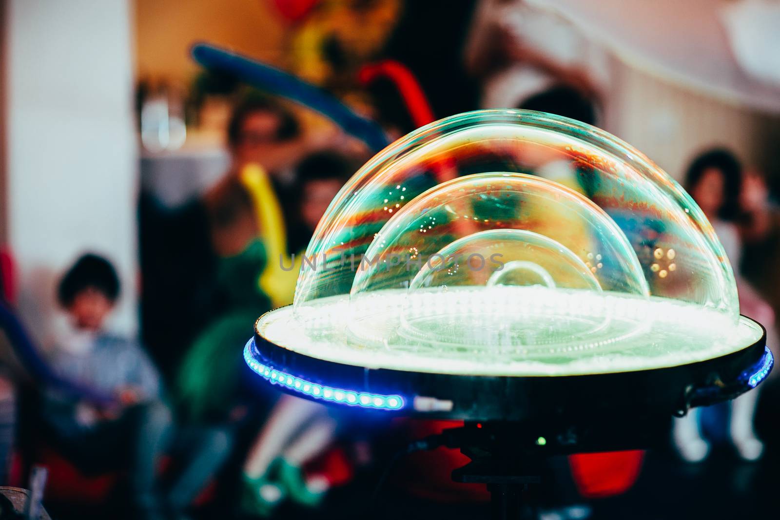 A large soap ball of green color on the table for soap balls. Show at the bottom of the child