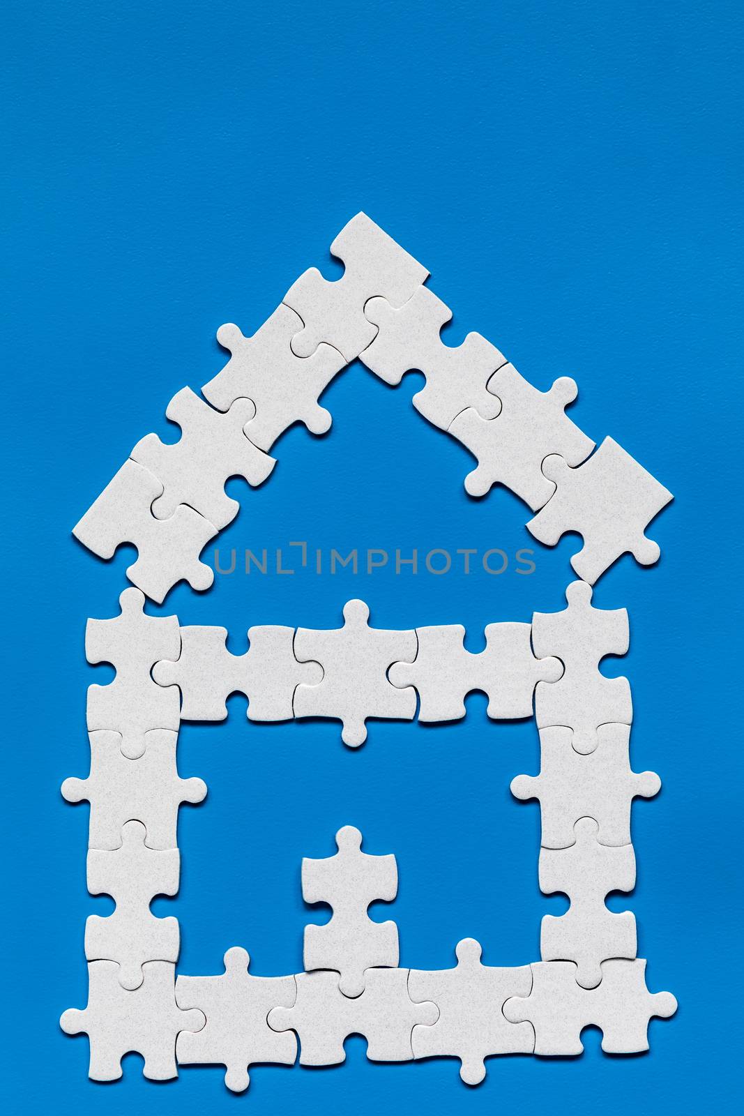 House made of puzzles. Modern house puzzle white pieces for concept design. Jigsaw Home, building, exterior. Puzzle construction renting, leasing, mortgage. House is made up of pieces of puzzles.