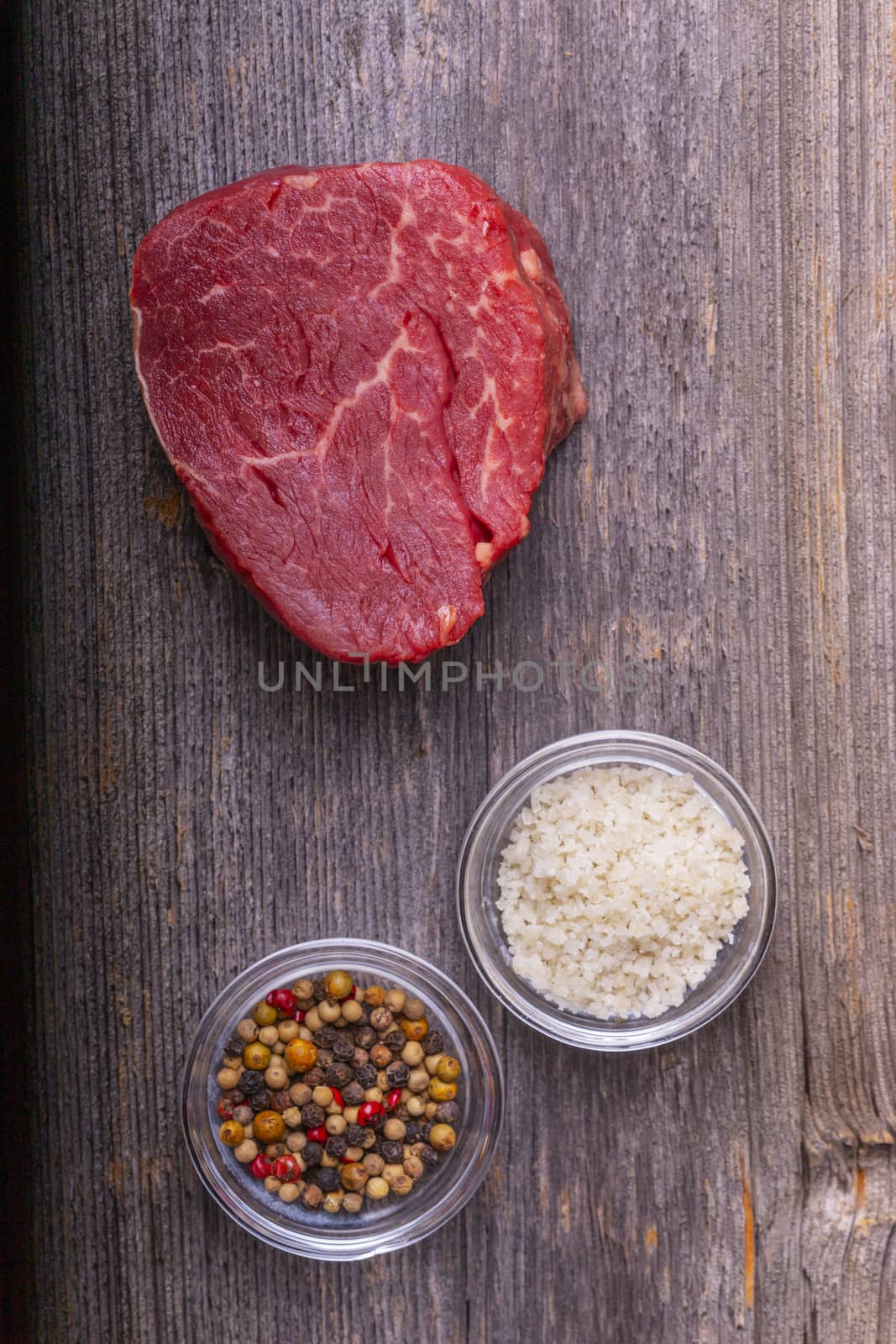 overview of a raw steak on wood