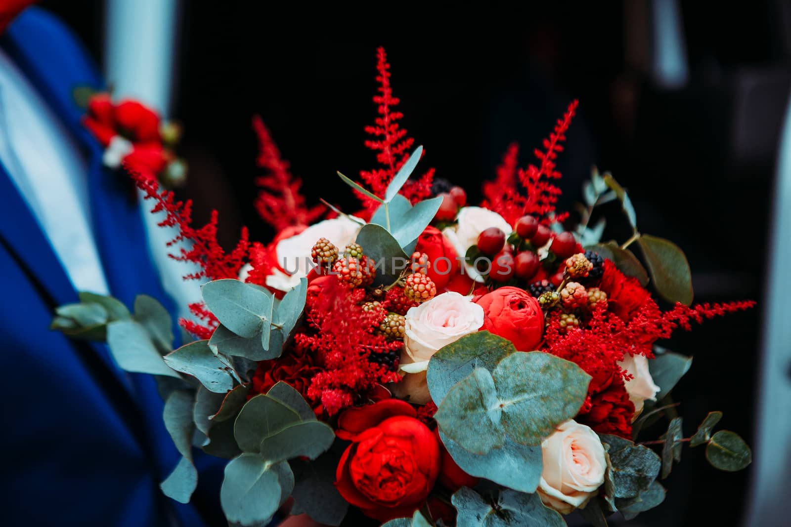 Wedding bouquet in the hands of the groom