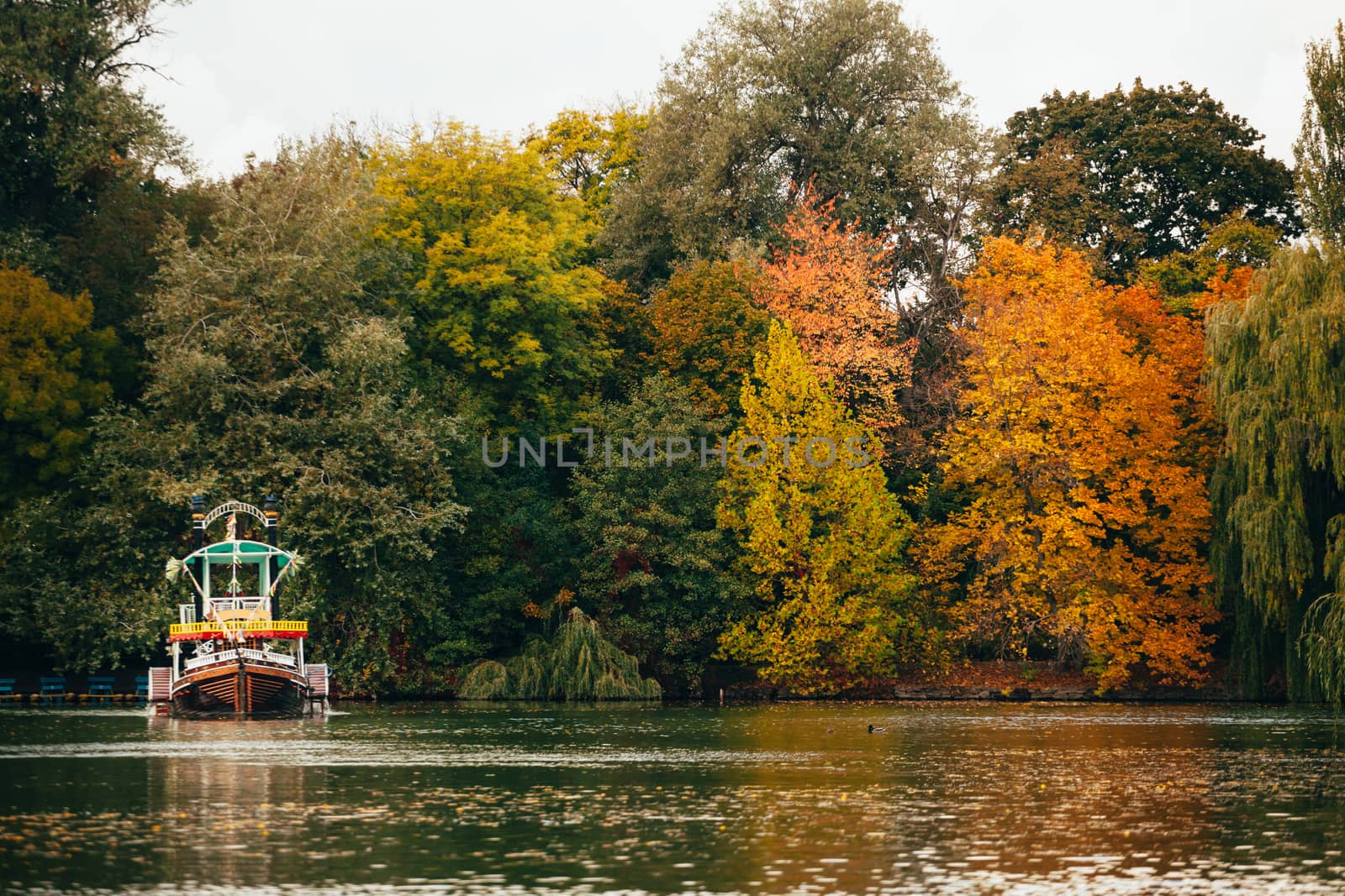 Boat on a large autumn lake by Opikanets