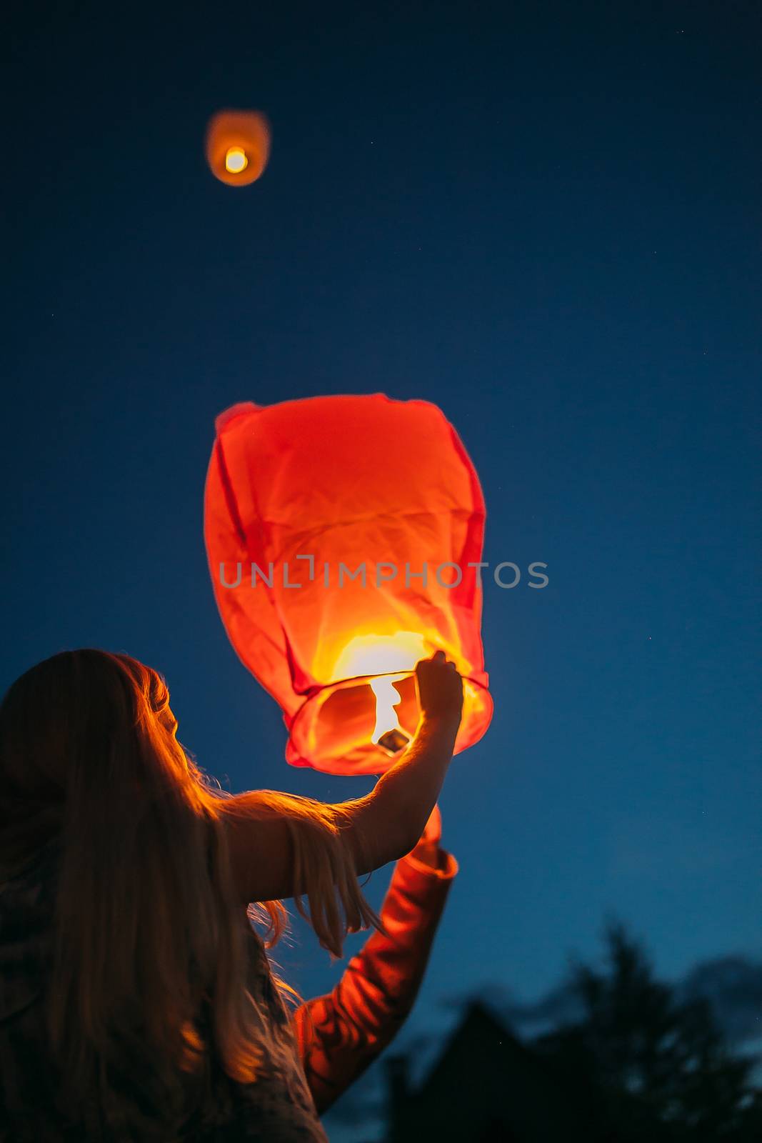 Launching Chinese lanterns at a street party by Opikanets