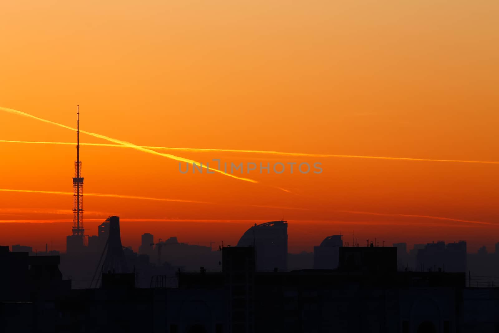 A television tower but against a background of bright orange sun by Opikanets