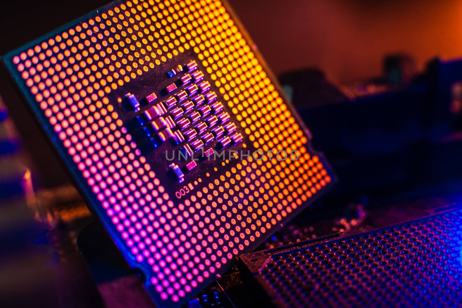 Processor with neon light. Large photo with blue-yellow light on a dark background.