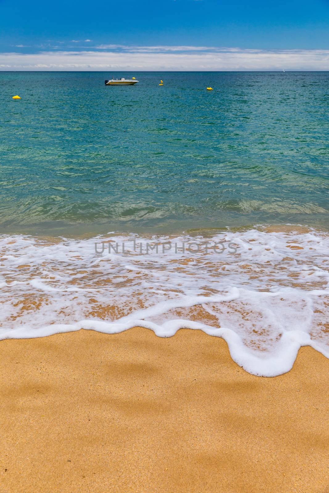 Blue ocean wave on sandy beach. Soft wave of blue ocean on sandy beach. Background. Top view of Beautiful beach with tranquil wave, sea and ocean background, summer vacation concept. 