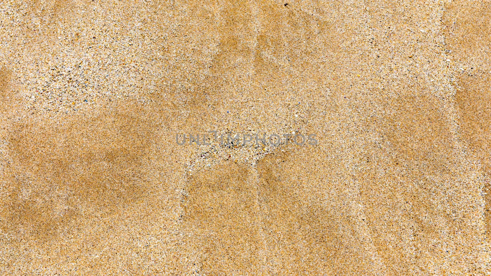 Sand surface and background. Sand Texture. Brown sand. Background from fine sand. Sand background. Closeup of sand pattern of a beach in the summer.