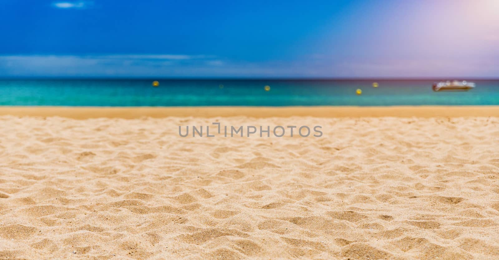 Soft wave of blue ocean on sandy tropical beach. Background of tropical paradise beach with golden sand, travel tourism panorama background concept. Sand and sea waves background.
