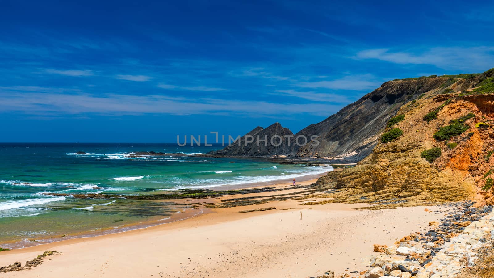 Wooden walkway to the beach Praia da Amoreira, District Aljezur, Algarve Portugal. Panorama from Amoreira beach in the Algarve Portugal. Beach and estuary of the Aljezur river, Praia da Amoreira.