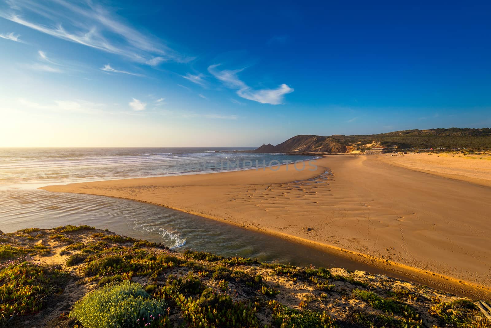 Wooden walkway to the beach Praia da Amoreira, District Aljezur, Algarve Portugal. Panorama from Amoreira beach in the Algarve Portugal. Beach and estuary of the Aljezur river, Praia da Amoreira.