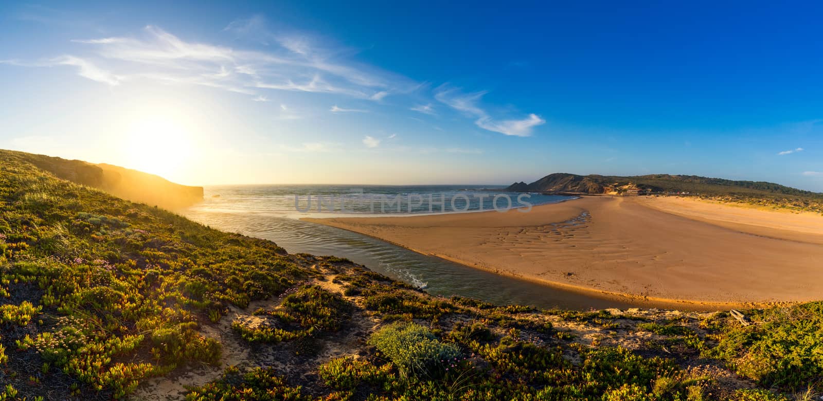 Wooden walkway to the beach Praia da Amoreira, District Aljezur, Algarve Portugal. Panorama from Amoreira beach in the Algarve Portugal. Beach and estuary of the Aljezur river, Praia da Amoreira.