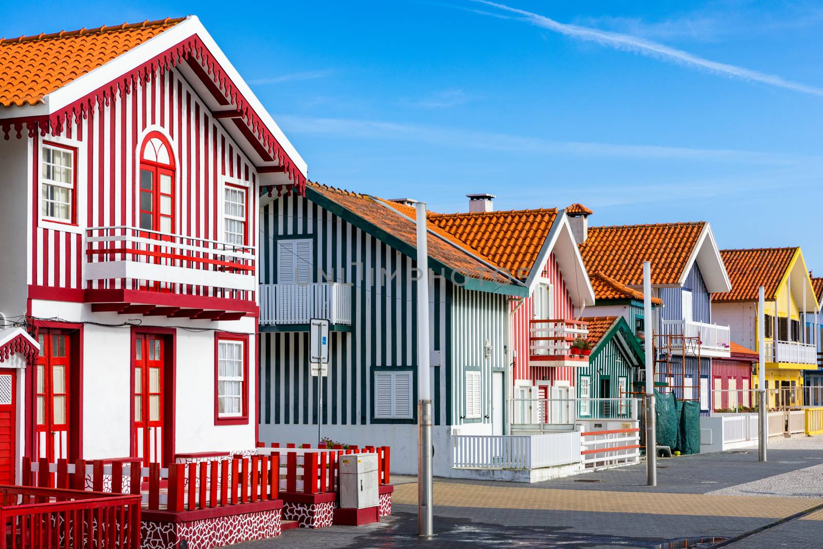 Street with colorful houses in Costa Nova, Aveiro, Portugal. Street with striped houses, Costa Nova, Aveiro, Portugal. Facades of colorful houses in Costa Nova, Aveiro, Portugal.