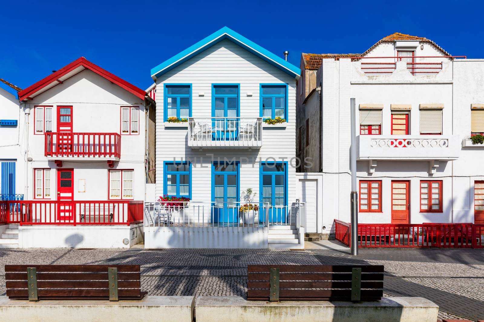 Street with colorful houses in Costa Nova, Aveiro, Portugal. Street with striped houses, Costa Nova, Aveiro, Portugal. Facades of colorful houses in Costa Nova, Aveiro, Portugal.