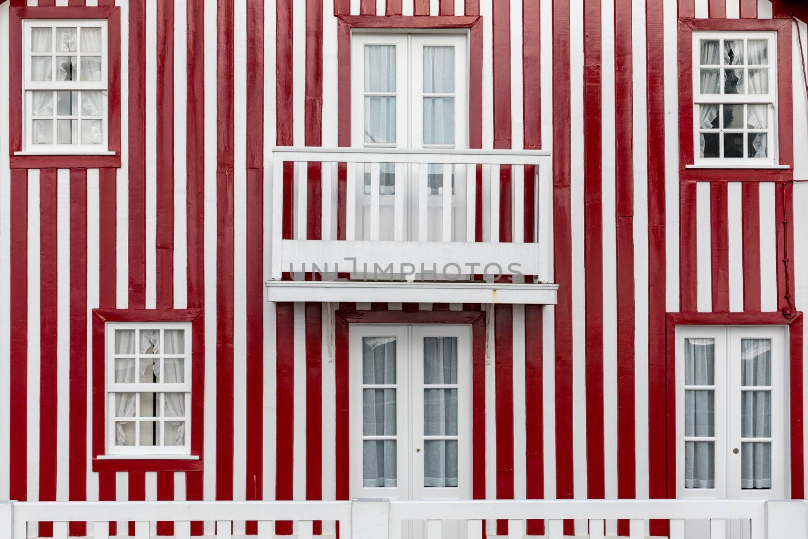 Colored Windows of "Costa Nova do Prado", Portugal. Windows in typical small wooden house with colorful stripes in Costa Nova. Aveiro. Portugal. Detail of the house in famous resort Costa Nova.