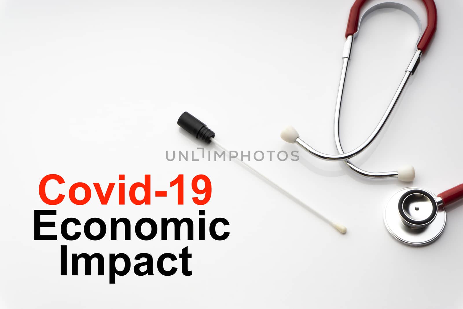 COVID-19 ECONOMIC IMPACT text with stethoscope and medical swab on white background by silverwings