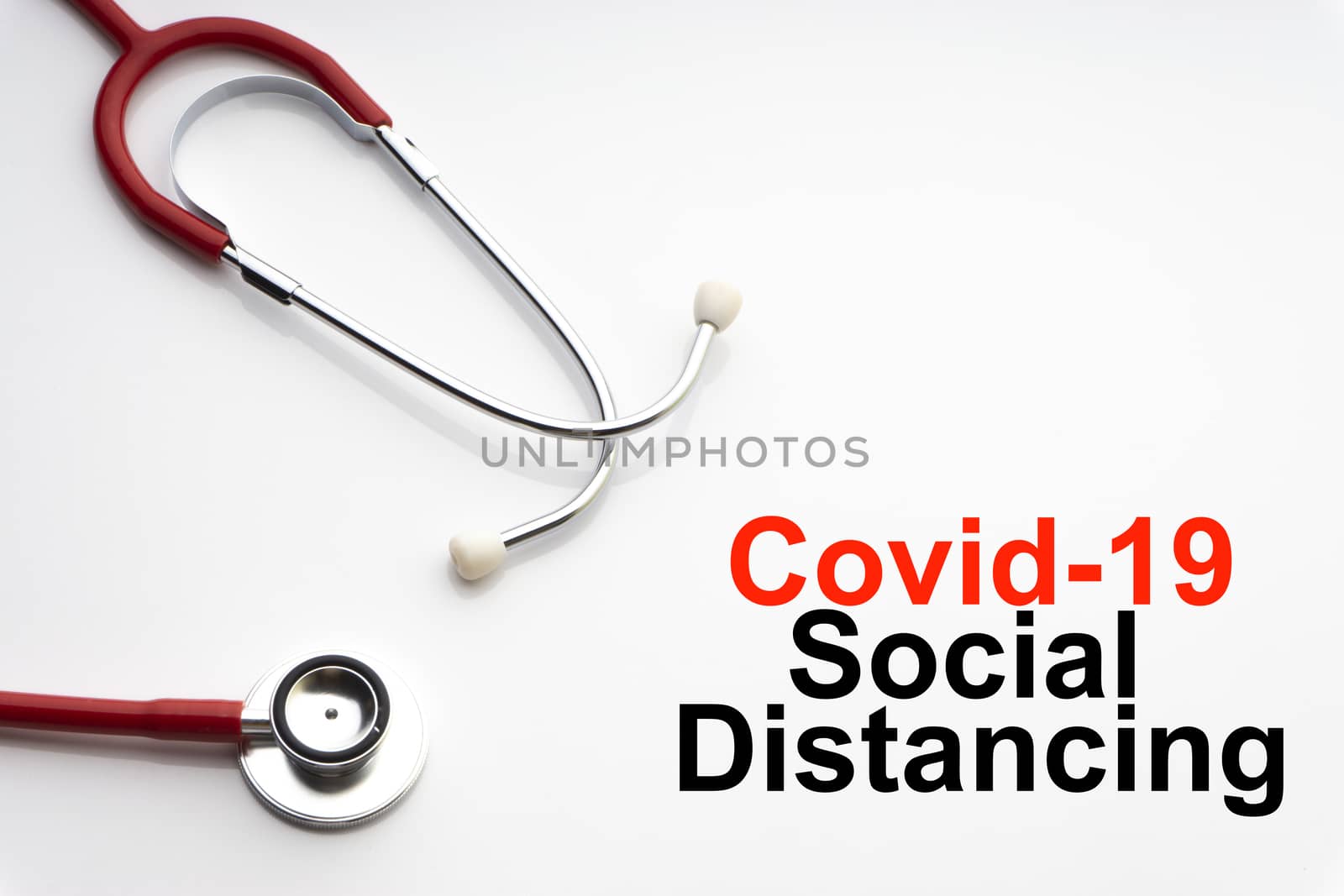 COVID-19 SOCIAL DISTANCING text with stethoscope on white background by silverwings